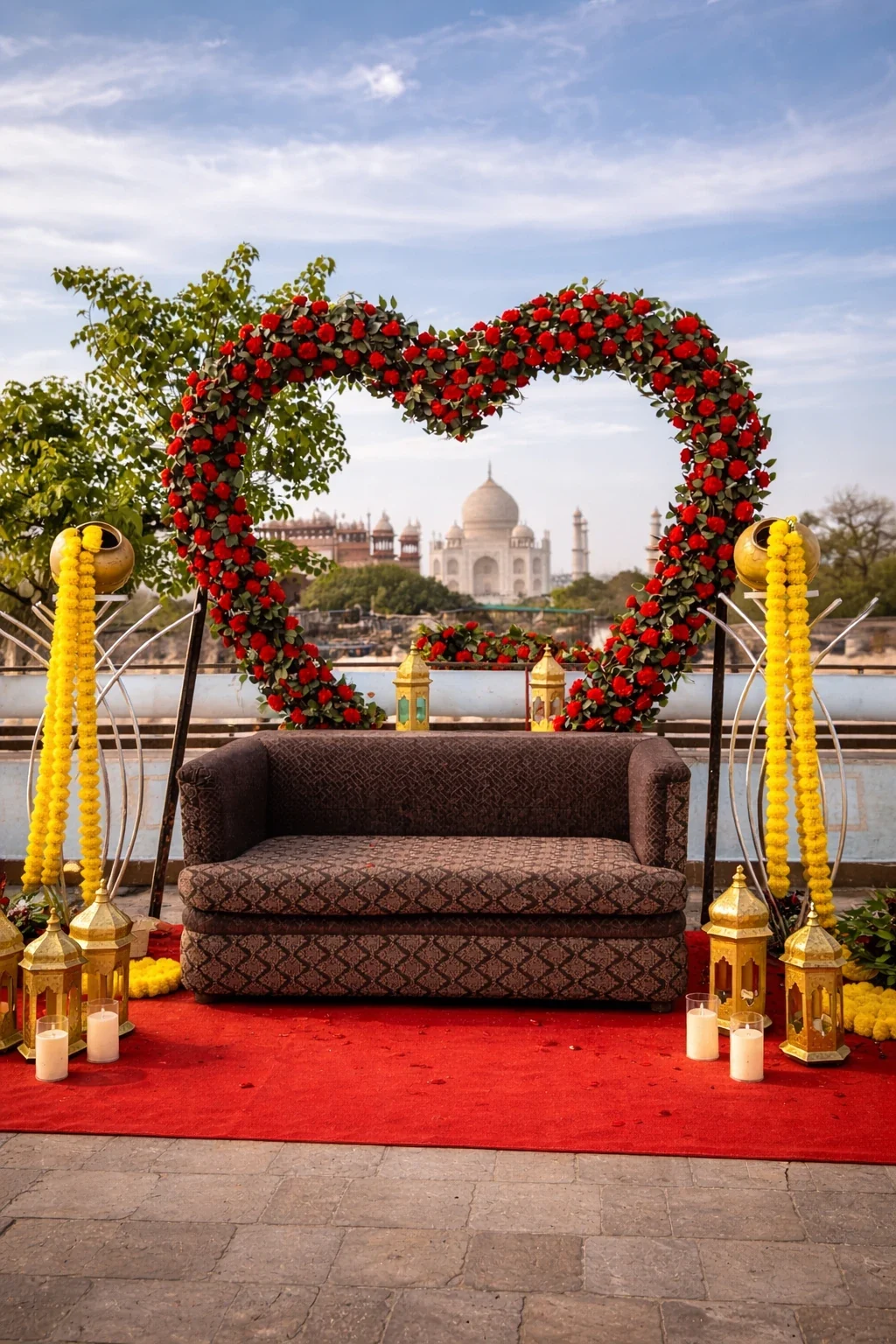 Rooftop celebration setup with red carpet and marigold garlands
